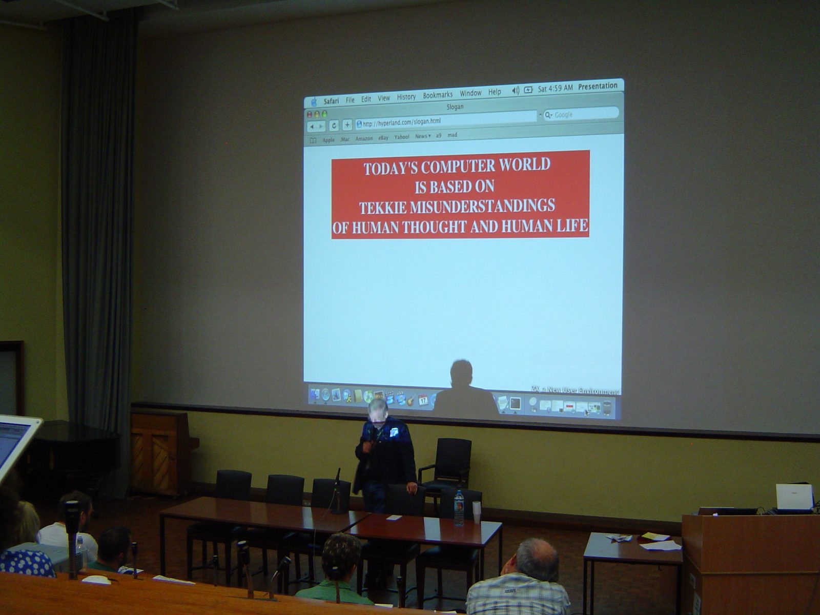 Ted Nelson speaking at OpenTech, London, 23 July 2005, beneath his slide: Today's computer world is based on tekkie misunderstandings of human thought and human life